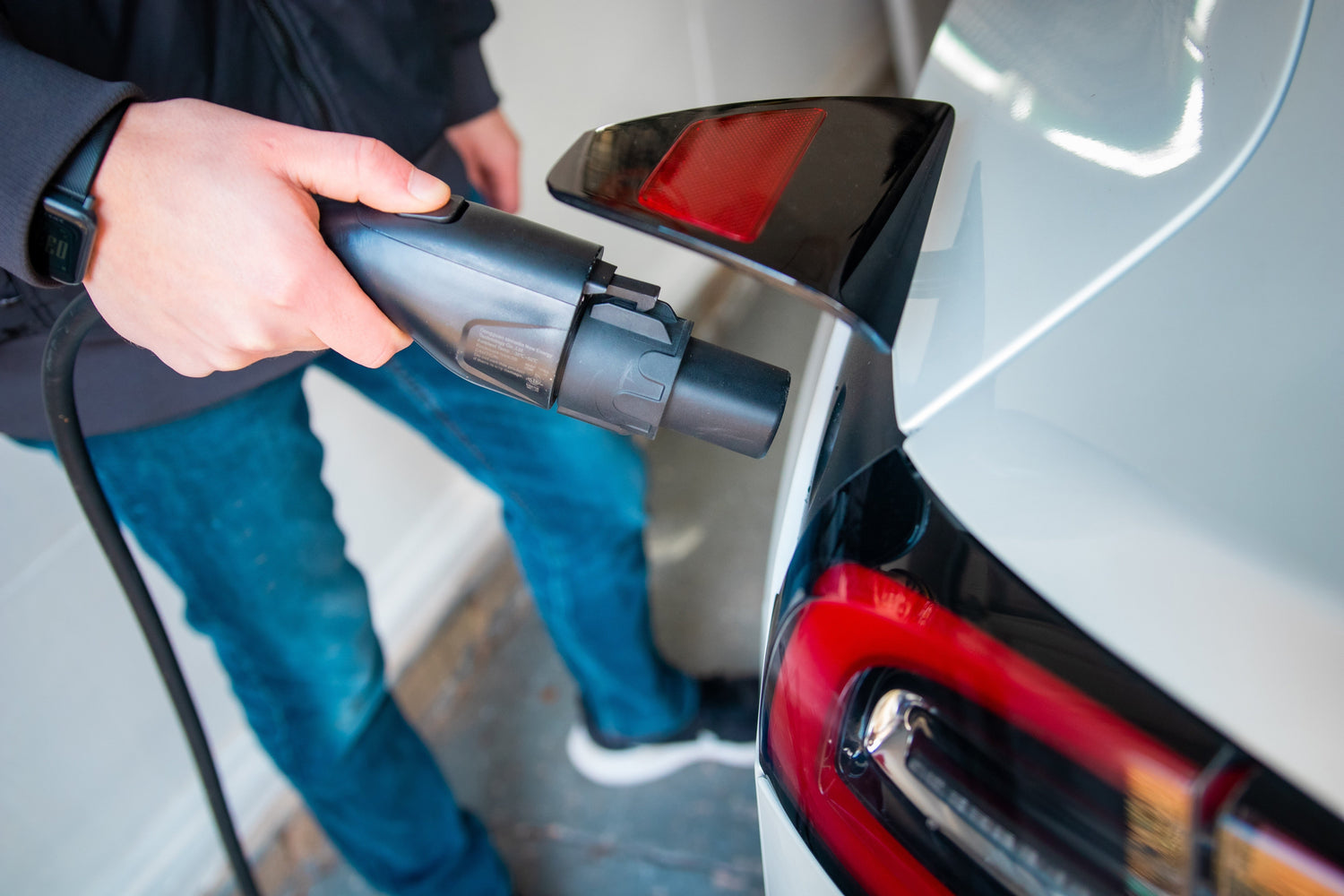 Electric vehicle owner exploring EV purchase tax credits and savings.