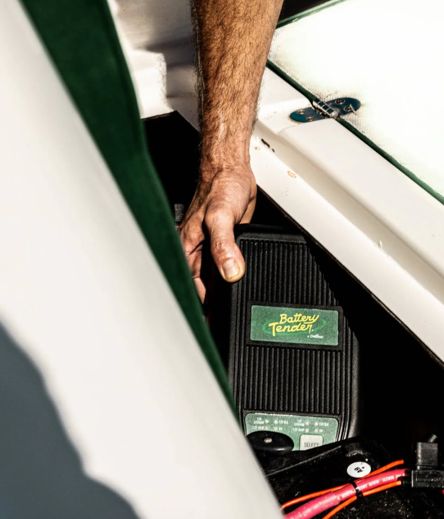 Person Storing the Battery Tender WaveCharge Pro 2-Bank Selectable 12V or 6V, 6 AMP Charger