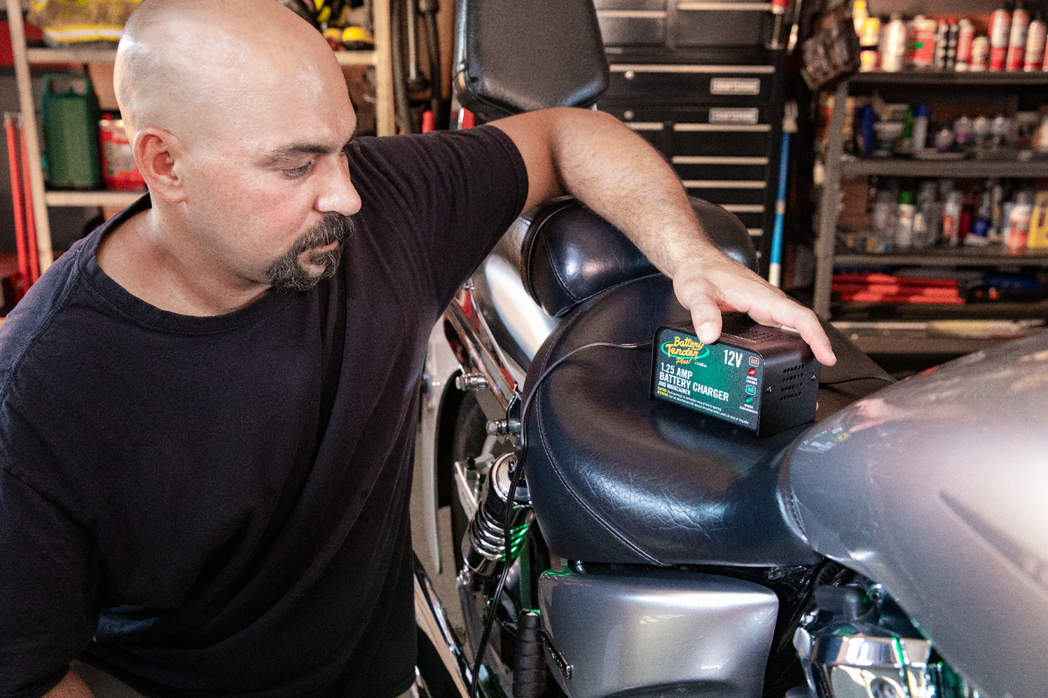 Man Using the Battery Tender Plus 12V, 1.25 AMP Battery Charger on Motorcycle