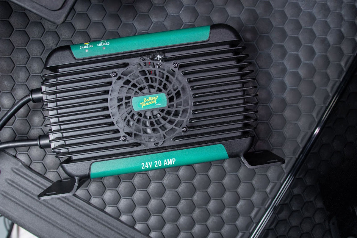Battery Tender® 48 volt battery charger connected to a golf cart in a sunny outdoor setting