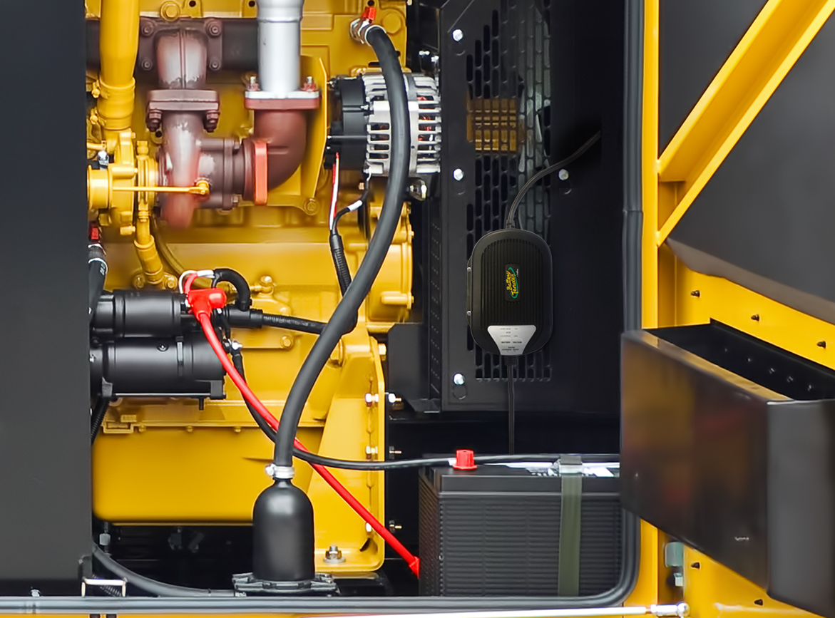 Battery Tender® charger connected to a farm tractor in a barn — farm equipment battery charger guide