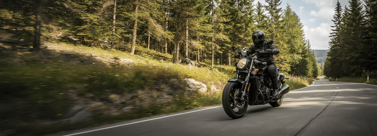Battery Tender® smart Harley Davidson battery charger connected to a touring motorcycle in a garage