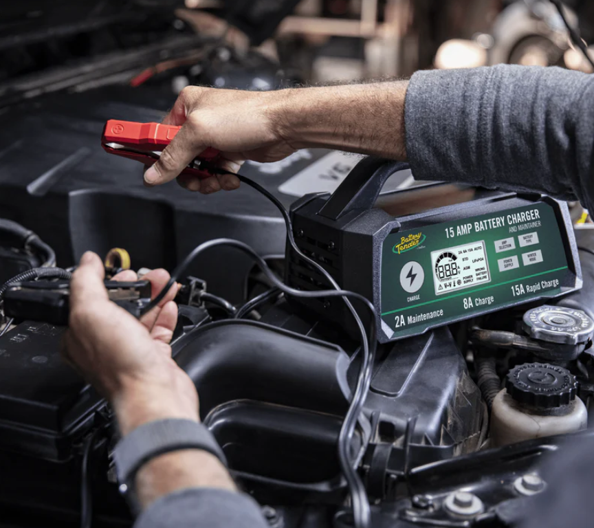 Battery Tender® deep cycle battery charger connected to a marine battery on a boat dock